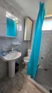 a bathroom with a sink and a toilet at Lucky Apartment in Nea Kalikratia