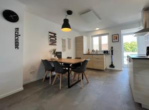 a kitchen and dining room with a table and chairs at Ferien-Monteurwohnung 201 Diwo Dillingen in Dillingen an der Saar