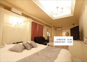 una camera da letto con un letto con un cartello sopra di ホテル カーシュ Cache 男塾ホテルグループ a Himeji