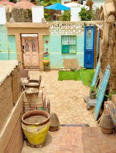a courtyard with a house with a blue door at Dream Catcher in Dahab