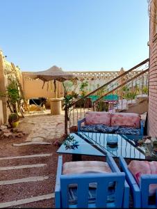 a patio with a table and chairs and an umbrella at Dream Catcher in Dahab