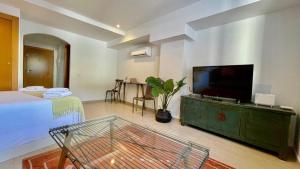 a bedroom with a flat screen tv on a dresser at Beach Panorama in Marbella
