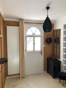 a room with a white door and a window at La Villa du Castel in Auriol