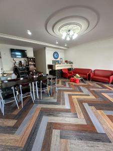a living room with a couch and a table and chairs at 小琉球觀海洋客棧View Ocean Inn in Xiaoliuqiu