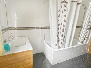 a bathroom with a shower curtain and a sink at Villa Francisca in Málaga +36 photos