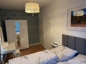 a bedroom with a bed and a desk and a mirror at Ferienwohnung Lucy - Moderne Ferienwohnung mit kostenlosem Parkplatz, Terrasse, nahe Bad Schandau und Malerweg in Bad Schandau