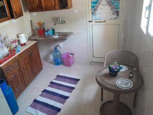 a small kitchen with a table and a sink at yaso apartment in Cairo