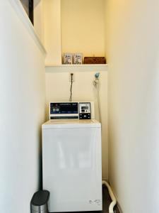 a small refrigerator in a room with a shelf at hotel kusanagi in Nanao