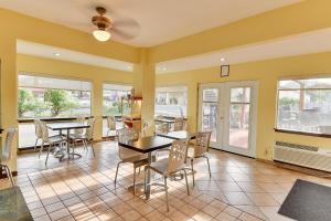 a dining room with tables and chairs and windows at Vagabond Inn Bishop in Bishop