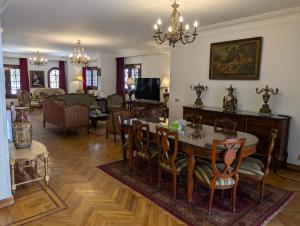 a living room with a table and chairs and a couch at Villa Maadi - 35 - R 1 Street view Room in Cairo