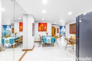 a dining room with a blue table and chairs at Waterfront Karon Beach by PHR in Karon Beach