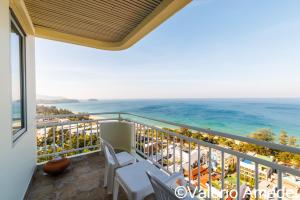 a balcony with a view of the ocean at Waterfront Karon Beach by PHR in Karon Beach