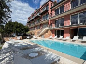 a swimming pool in front of a building at Hotel Villa Leopardi 4S - Adults only in Torri del Benaco