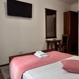 Voodi või voodid majutusasutuse Hotel Paviljon toas