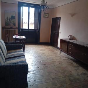 a living room with a couch and a table at Casa 28 Luglio - Camera Matrimoniale in Mercatello sul Metauro +7 photos