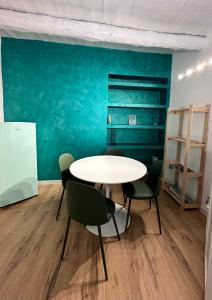 a table and chairs in a room with a blue wall at Portobello In Centro in Salerno