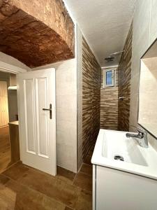 a bathroom with a sink and a white door at Portobello In Centro in Salerno