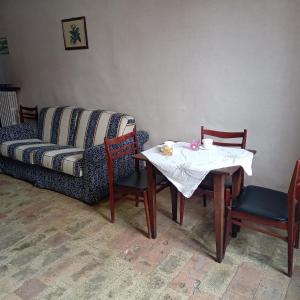 a living room with a table and a couch at Casa 28 Luglio - Camera Matrimoniale in Mercatello sul Metauro