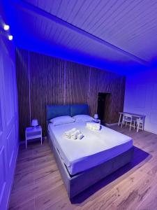 a bedroom with a bed in a blue room at Portobello In Centro in Salerno