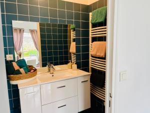 a bathroom with a sink and a mirror at Maison entre Saumur et Montreuil Bellay La Motte in Artannes-sur-Thouet +6 photos