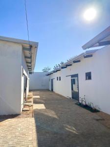 eine leere Gasse zwischen zwei weißen Gebäuden in der Unterkunft Casa Davisis - PX da JK e Centro - Ate 8 Hospedes in Palmas