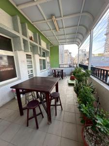 a table and chairs on a balcony with a view at 小琉球觀海洋客棧View Ocean Inn in Xiaoliuqiu