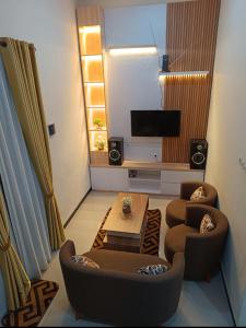 a living room with two couches and a table at VILLA BATU 3F in Batu