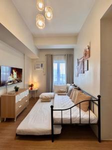 a bedroom with a large bed in a room at 8F Cozy 1-Bedroom Unit The Loop Towers in Cagayan de Oro