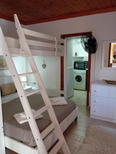 a room with a bunk bed and a kitchen at Alice apartment in Mesochórion