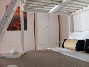 a bedroom with a bunk bed with a ladder at Alice apartment in Mesochórion