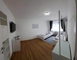 a living room with white walls and wooden floors at Annabella Apartment in Graz