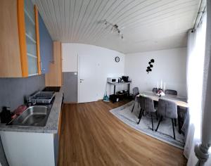 a kitchen with a table and chairs in a room at Annabella Apartment in Graz