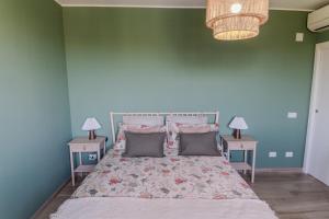 a blue bedroom with a bed with two night stands at Casa Gaia - Villetta a pochi passi da Roma in Ciampino