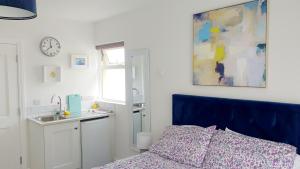 a bedroom with a bed and a sink and a clock at The Lodge in Killarney