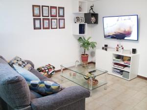 a living room with a couch and a glass table at Hostal La Provinciana in A Coruña