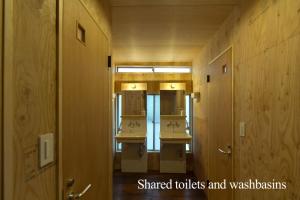 a bathroom with four sinks and a row of mirrors at hanare in Tokyo