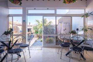 a room with a table and chairs and a patio at Casa Areal de Santa Barbara in Ribeira Grande