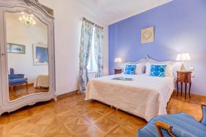 a blue bedroom with a bed and a mirror at IPEKYOL Guesthouse in Çeşme +10 photos