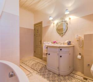 a bathroom with a sink and a toilet and a mirror at IPEKYOL Guesthouse in Çeşme