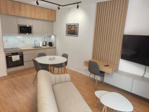 a living room with a couch and a table and chairs at modern apartment in Senica +6 photos