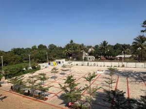 a park with trees in the middle of it at Sairaj Lawns in Belgaum