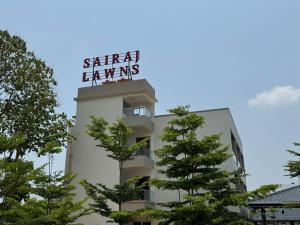 a building with a sign on top of it at Sairaj Lawns in Belgaum
