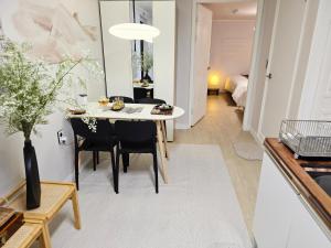 a dining room and living room with a table and chairs at YNNY stay#Yeongdeungpo#Yeouido#7-8 minutes walk from Daebang Station-Line1 and Singil Station-Line1,5 in Seoul
