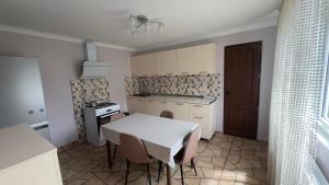 a kitchen with a table and chairs and a stove at Family house in Ach'khoti