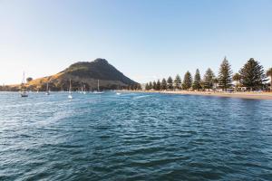 a view of a beach with boats in the water at Mount Maunganui Gem Long Stay Ready Steps to It All in Mount Maunganui