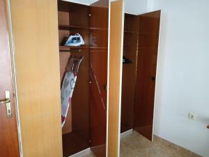 a closet with wooden cabinets and a vacuum at Dimado Family in Kavála