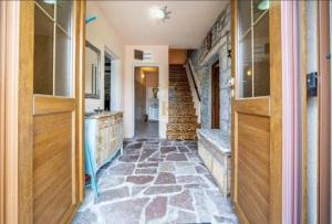 a hallway with a stone floor in a house at Villa Mara Lustica Bay Retreat near Kotor, Tivat in Tivat