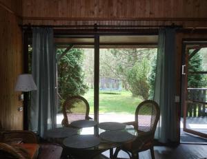 a dining room with a table and chairs and a window at Dom Pilchy nad jeziorem Roś in Pilchy +6 photos