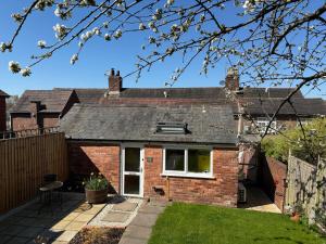 a red brick house with a roof at Cherry Cottage Retro Stay, Stourport-on-Severn in Stourport