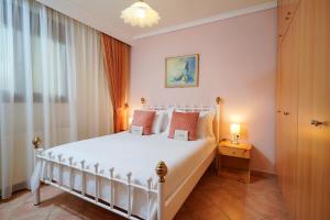 a bedroom with a white bed in a room at Althea in Skala Potamias